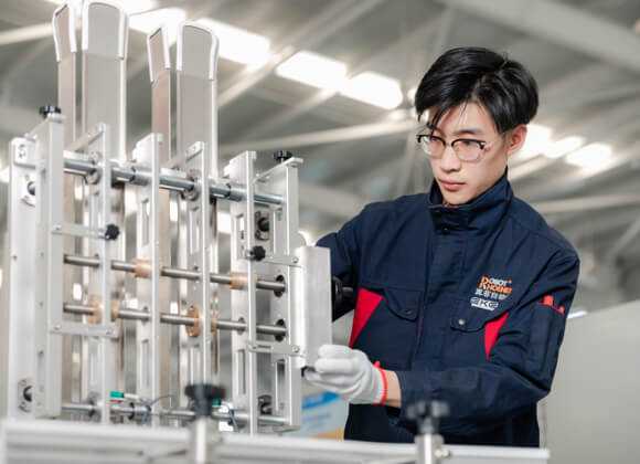 A worker is assembling the industry robot