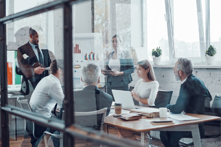 A group of people are having a meeting in the conference room