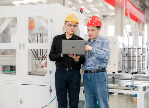 2 men are discussing while pointing to the laptop