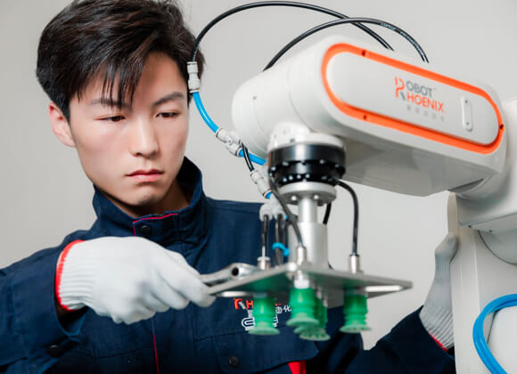 Worker is repairing the robot