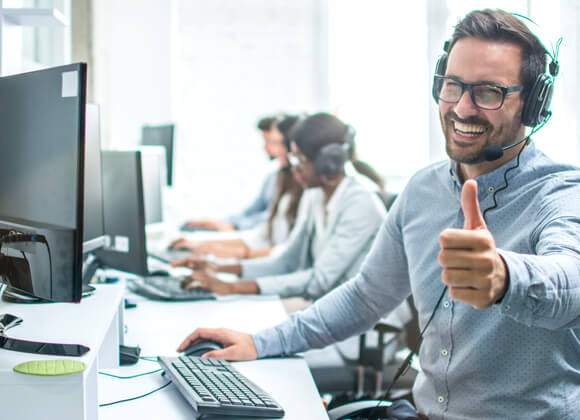 A white man is giving a thumb up