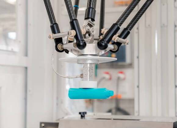 Robot is handling a blue bottle