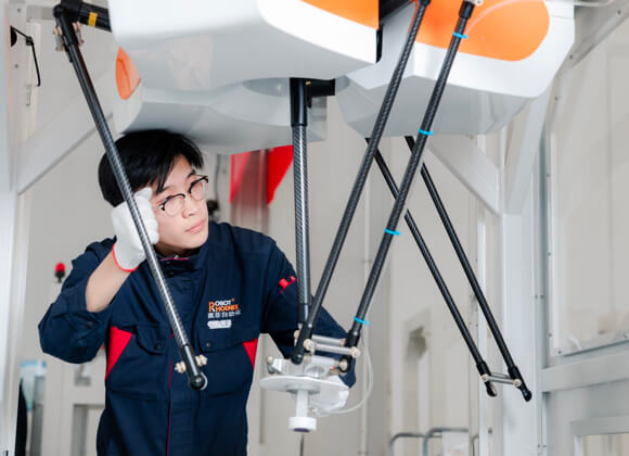 A worker is assembling the automated system